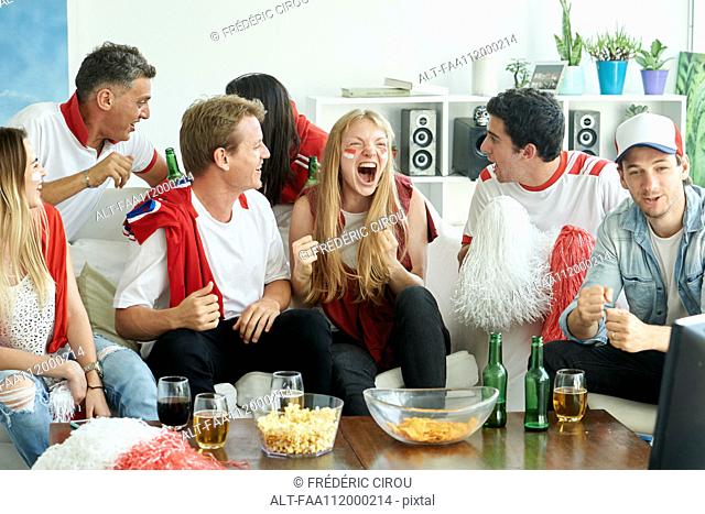 English soccer fans watching match together at home