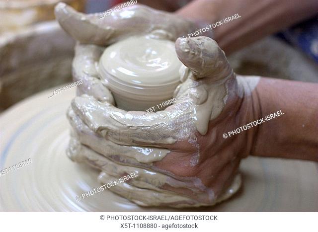 Making a clay pot on a potter's wheel