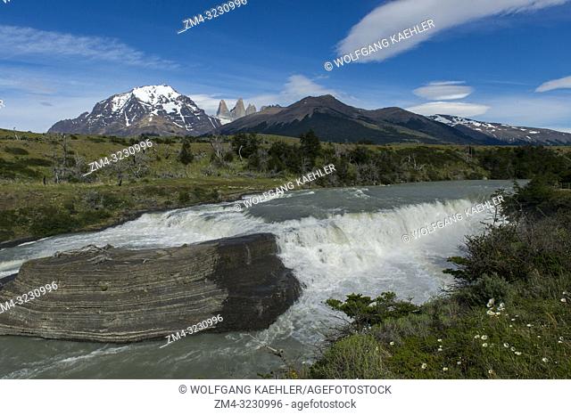 View of the Paine River waterfall with Admiral Nieto Mountain (left) and the Torres del Paine (Towers of Paine) in Torres del Paine National Park in southern...