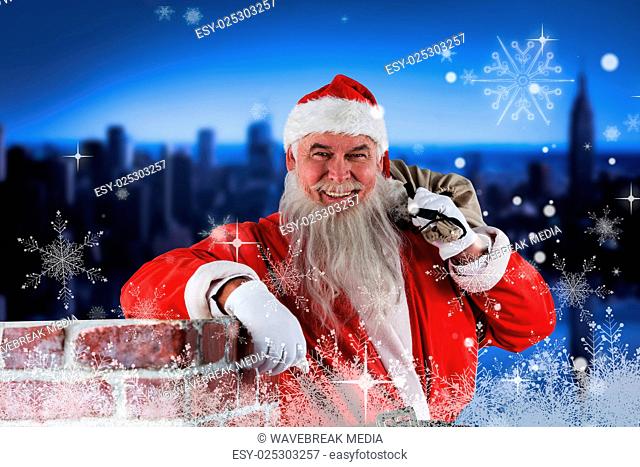 Composite image of portrait of santa claus carrying bag full of gifts