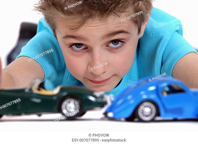 Little boy playing with toy cars