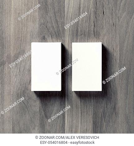 Photo of blank white business cards on vintage wood background. Top view. Flat lay