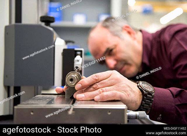 Man examining product in a factory