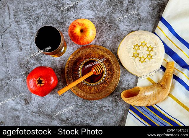 Rosh hashanah with glass honey jar and fresh ripe apples. Jewish new year symbols shofar and tallit