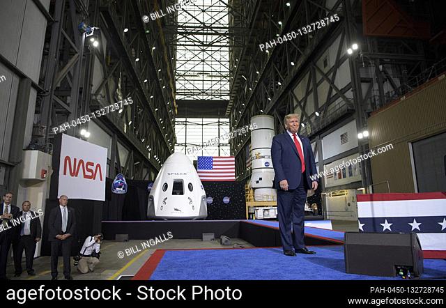 In this photo released by the National Aeronautics and Space Administration (NASA), President Donald Trump speaks inside the Vehicle Assembly Building following...