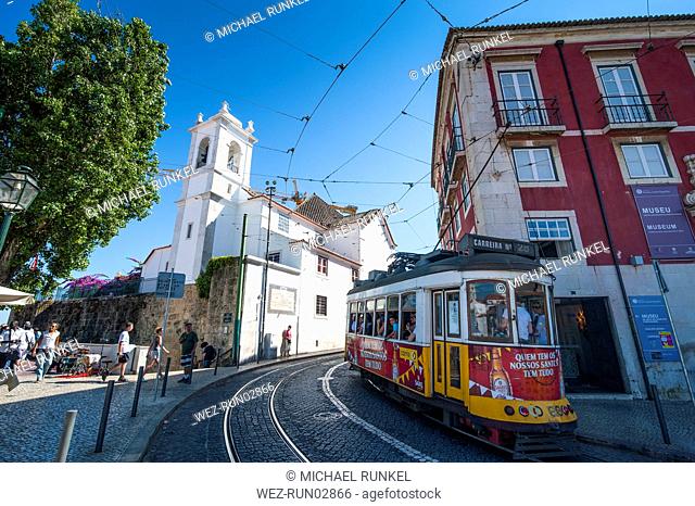 Tram passing in old town of Alfama, Lisbon, Portugal