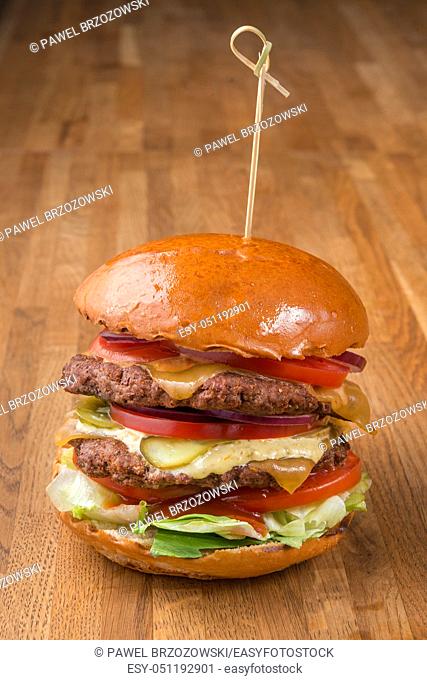 Beef burger on wooden background. For fast food restaurant design or fast food menu