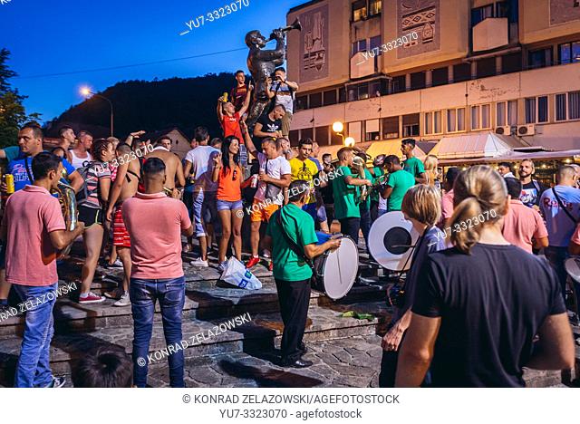 Street musicians playing Balcan music for money in front of Trumpeter Monument during famous annual Trumpet Festival in Guca village, Serbia