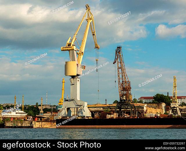 Sevastopol, Russia - June 09, 2016: Lifting cargo cranes at the shipyard in Bay of Black Sea