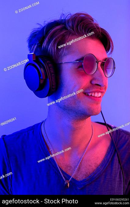 dj with headphones in nightclub party scene, toned image
