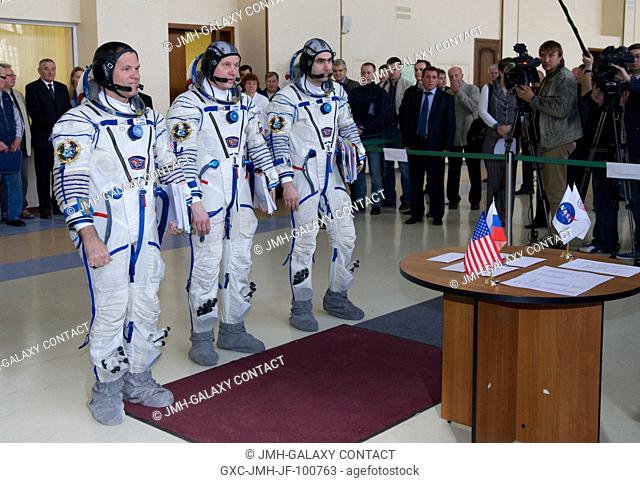 Expedition 31 backup crew members Kevin Ford, Oleg Novitskiy and Evgeny Tarelkin stand at attention before senior officials for their final qualification test...