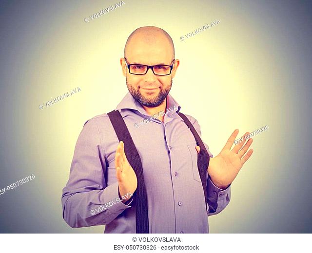 Funny bald man in the shirt keeps the suspenders. Businessman with glasses