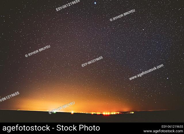 Night Sky Glowing Stars Background Backdrop. Colorful Sky Gradient. Sunset, Sunrise And Town Lights At Horizon. Colourful Night Starry Sky In Yellow Orange...
