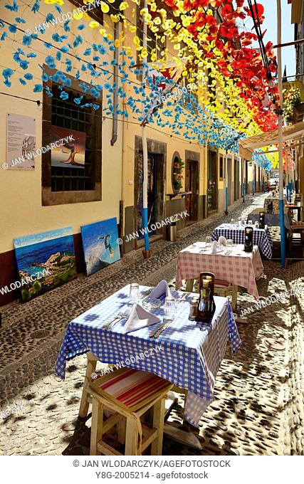Street decorated with paper flowers on feast of Madeira, Funchal old town, Madeira, Portugal