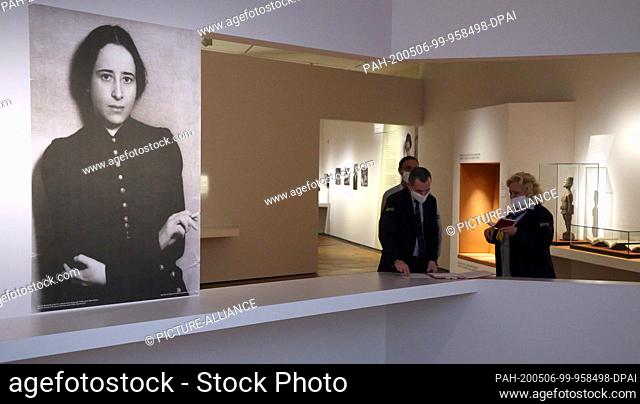 06 May 2020, Berlin: Members of a security service stand with protective masks during the press tour of the exhibition ""Hannah Arendt and the 20th century"" in...
