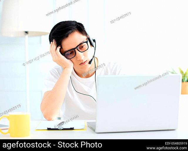 young man working from home with laptop