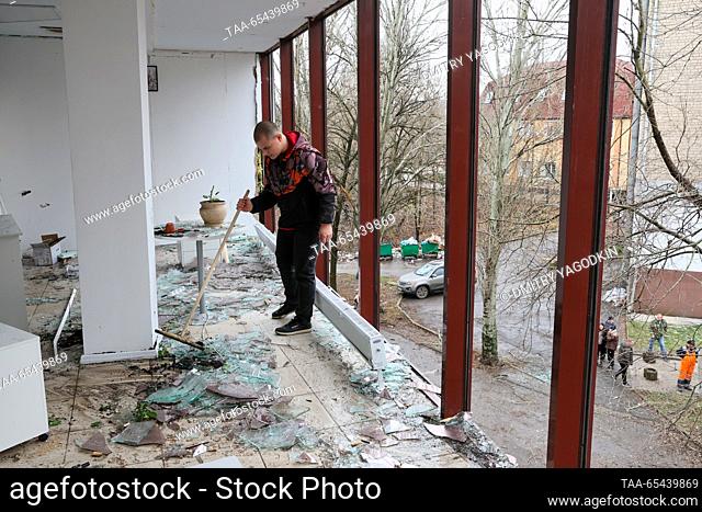 RUSSIA, DONETSK - DECEMBER 3, 2023: A man clears broken glass from the floor of a beauty parlour damaged in a shelling attack by the Ukrainian Armed Forces