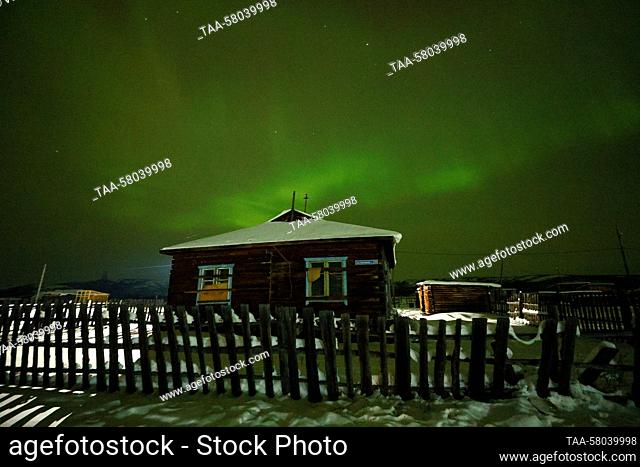 RUSSIA, REPUBLIC OF SAKHA (YAKUTIA) - MARCH 23, 2023: The Northern Lights, or the Aurora Borealis, shine over the village of Dzhargalakh in the...