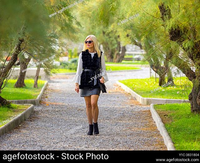 Mid-adult woman walking alone in park