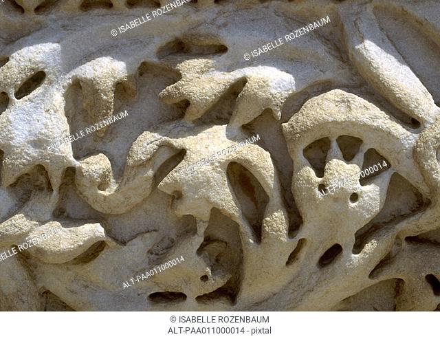 Stone carving with floral motif, worn away, close-up