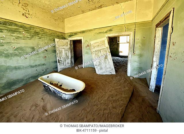 Desert sand in the ruined building of the former diamond city, ghost town, Kolmanskop, Lüderitz, Namibia