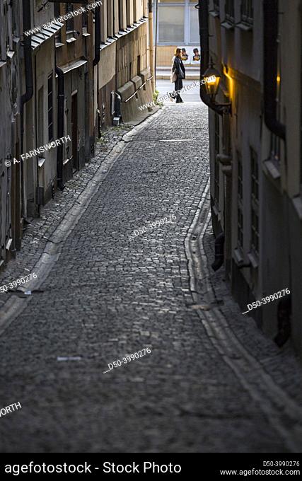 Stockholm, Sweden A pedestrian walks on Stora Hoparegrand on Gamla Stan or Old Town