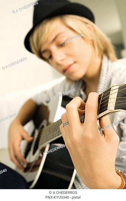 Teenage boy playing a guitar