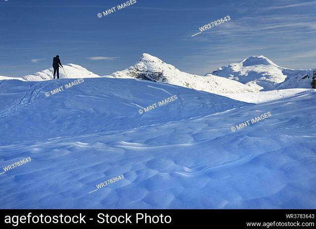 Skier on the snow, backcountry skiing, in deep snow