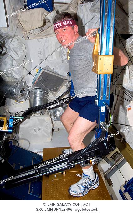 NASA astronaut Mike Fossum, Expedition 29 commander, exercises using the advanced Resistive Exercise Device (aRED) in the Tranquility node of the International...