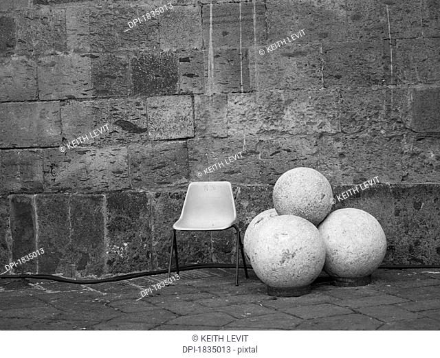 Chair, round rocks, Castle Nuovo, Naples, Italy