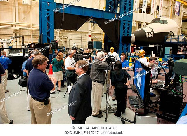 NASA personnel and members of the media are pictured during Robonaut 2 (R2) media day in the Space Vehicle Mock-up Facility at NASA's Johnson Space Center