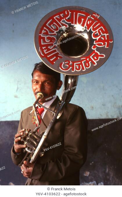A musician of a brass band is playing tuba ( Rajasthan, India)