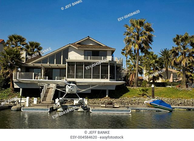 Executive house on the water with seaplane