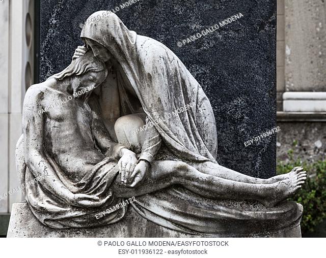 More than 100 years old statue. Cemetery located in North Italy