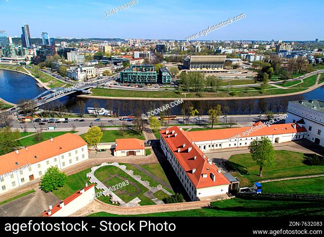 View of Vilnius city in Lithuania, with historical architectural structures, buildings around, with a flowing river, on blue clear sky background