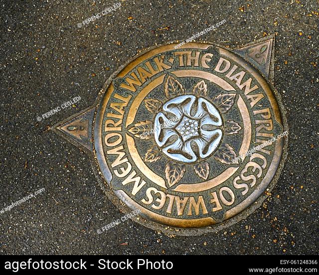 Princess Diana Memorial Directional sign. The plaque embedded into the pavement showing the direction of the path between the Diana memorials, London