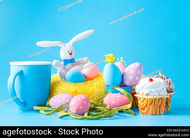 Colorful decoration of kids birthday party table with easer eggs and sweets