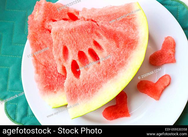 close-up on the table are two pieces of watermelon