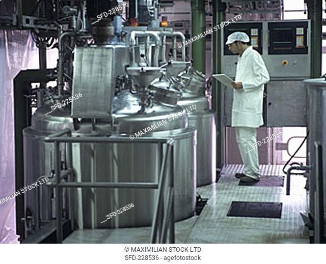 Technician checking production process in jam factory