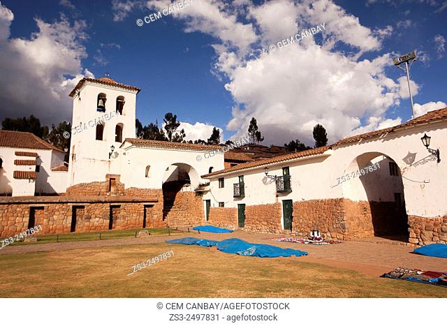 Indigenous women selling crafts at town center with the bell tower at the background, Chinchero, Valle Sagrado, Cuzco, Peru, South America