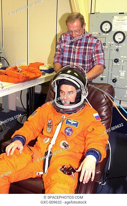 05/28/2002 - During suit check, part of pre-launch activities, Expedition 5 Commander Valeri Korzun gets help with his helmet