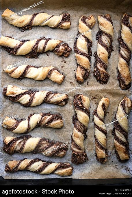 Vegan puff pastry nut twists on a baking tray