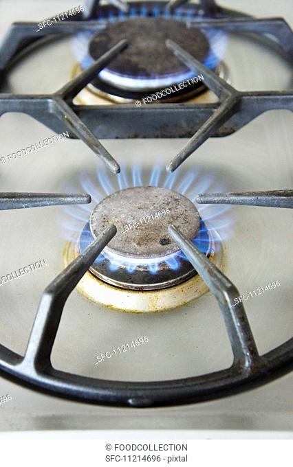 Lit gas rings on the hob (close-up)