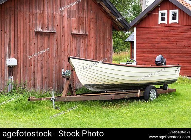 Forsmark, Osthammar - Sweden -07 31 2019- small boat and red wooden houses