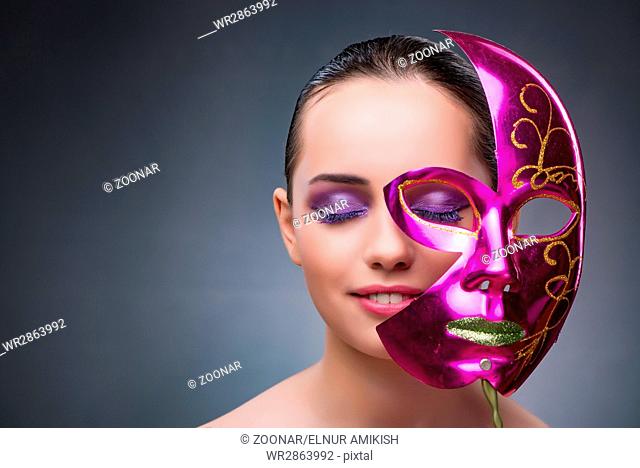 Young woman with carnival mask