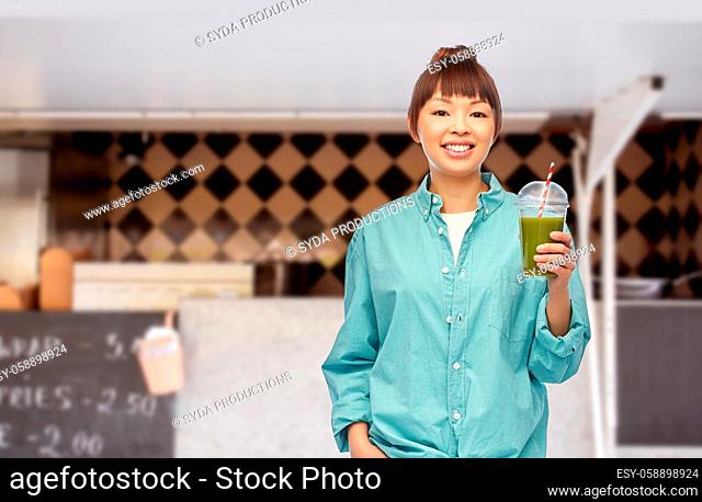 happy asian woman with juice over food truck