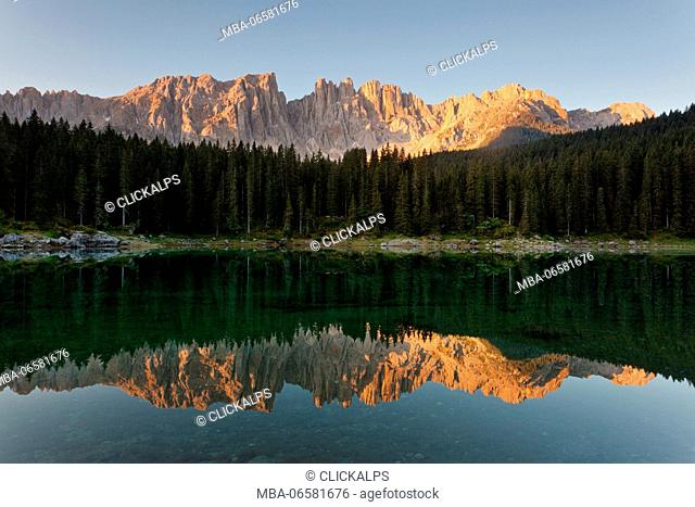Carezza lake, Dolomites, Trentino-Alto Adige, Italy, Latemar group are reflected into the Carezza's lake in the sunrise