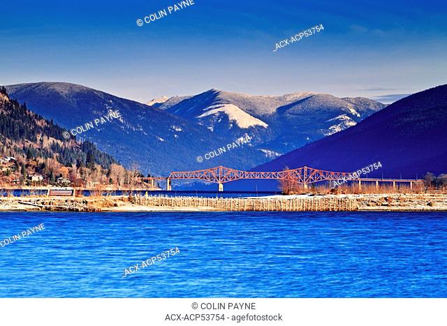 A sunny early winter day on the waterfront in Nelson, BC with the Big Orange Bridge in the background