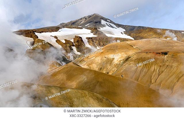 Hikers in the geothermal area Hveradalir in the mountains Kerlingarfjoell in the highlands of Iceland. Europe, Northern Europe, Iceland, August