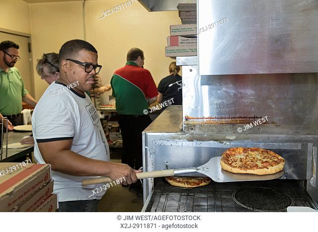 Detroit, Michigan - A kitchen crew makes pizzas to feed the thousands of volunteers who participated in an annual community improvement project called Life...